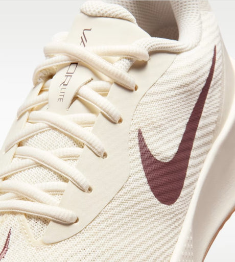 A close up of a beige and brown nike tennis shoe