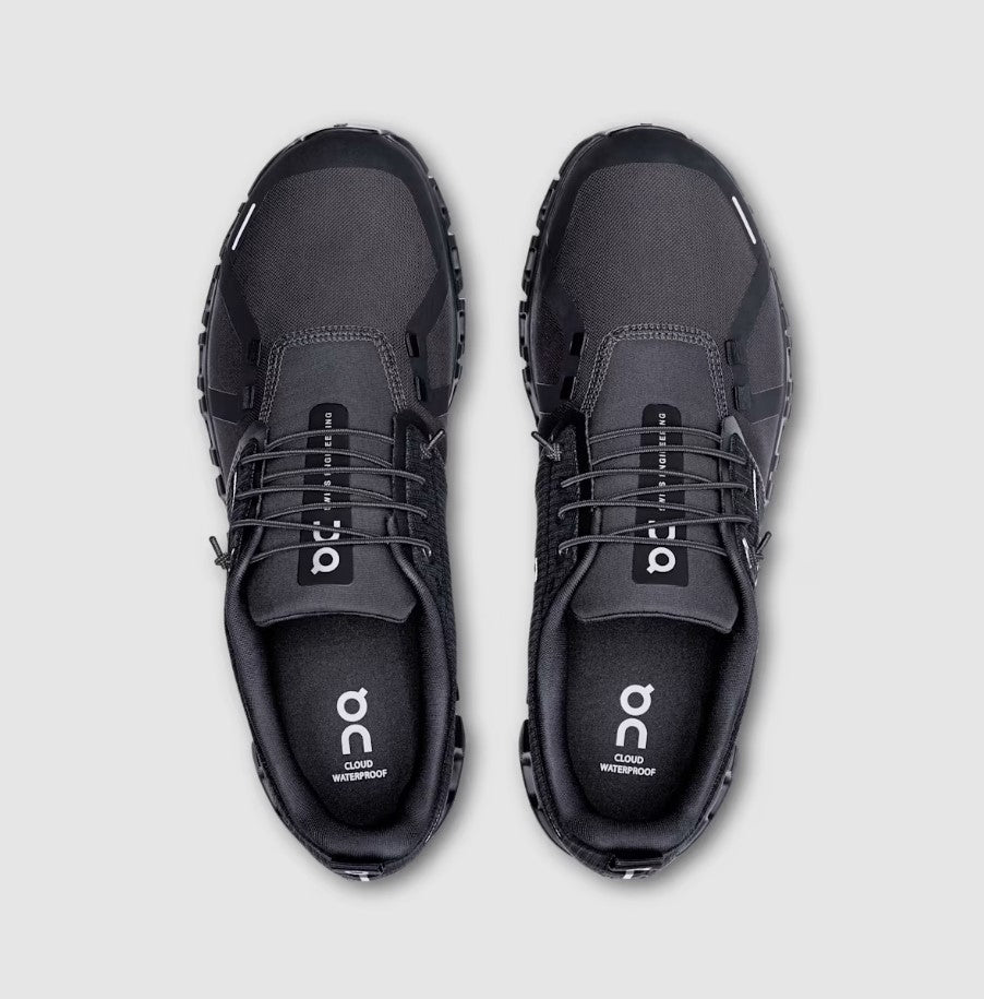 Pair of black athletic shoes on a light gray background