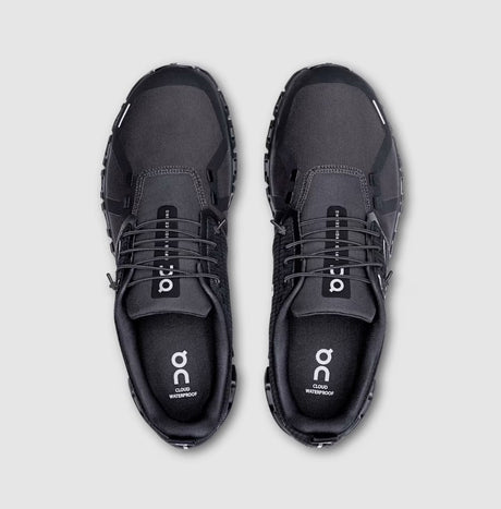 Pair of black athletic shoes on a light gray background