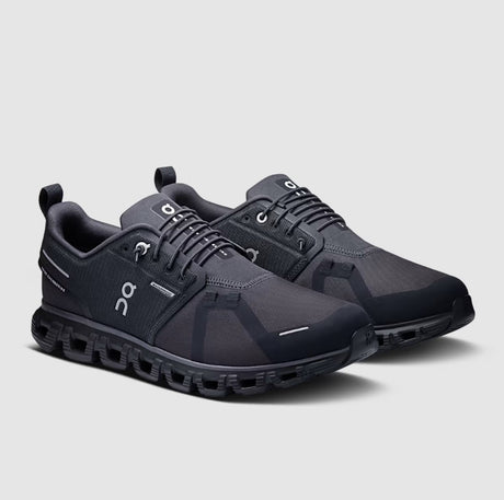 Pair of black athletic shoes on a light gray background