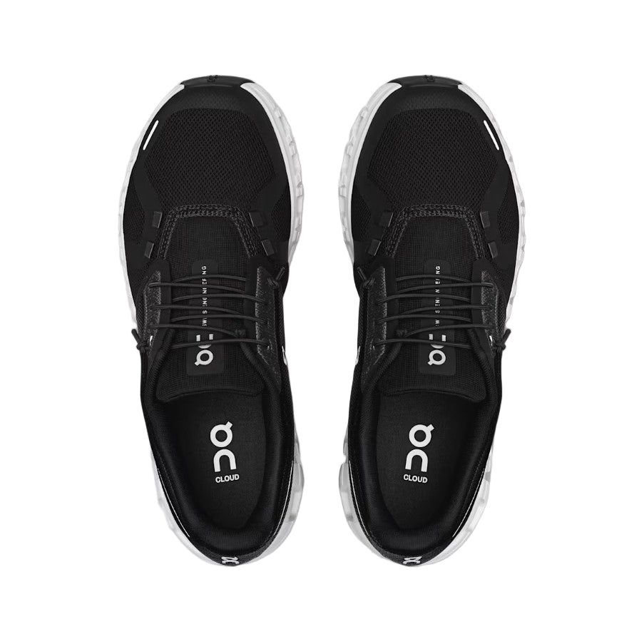 Black running shoes with 'on' logo on a light gray background