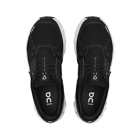 Black running shoes with 'on' logo on a light gray background