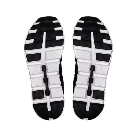 Black and white sole of a shoe on a light gray background