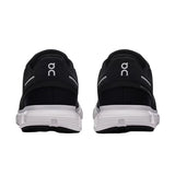 Black running shoes with white sole on a light gray background