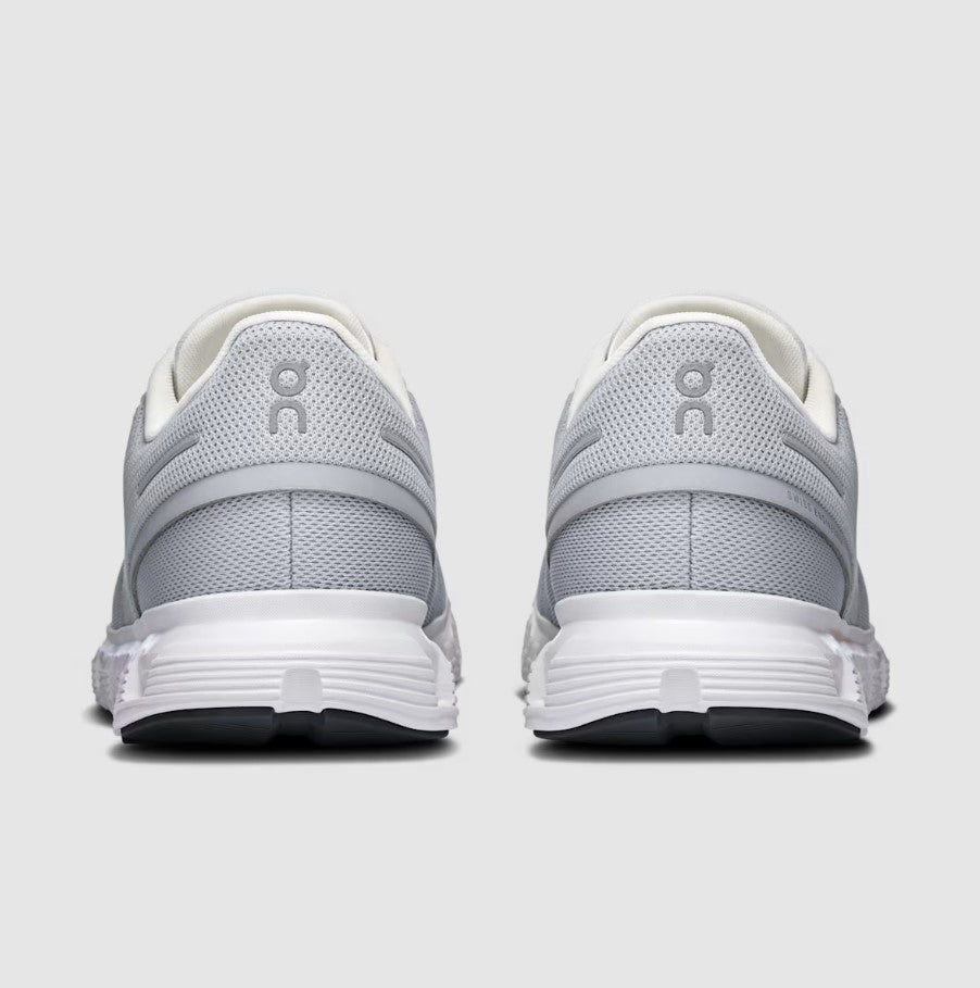 Gray and white running shoes with a visible brand logo on a light gray background