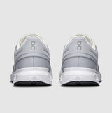 Gray and white running shoes with a visible brand logo on a light gray background