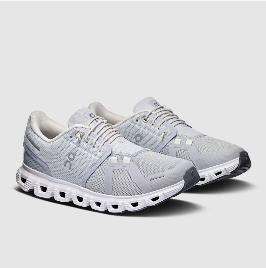 Gray running shoes with white sole on a light gray background