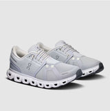 Gray running shoes with white sole on a light gray background