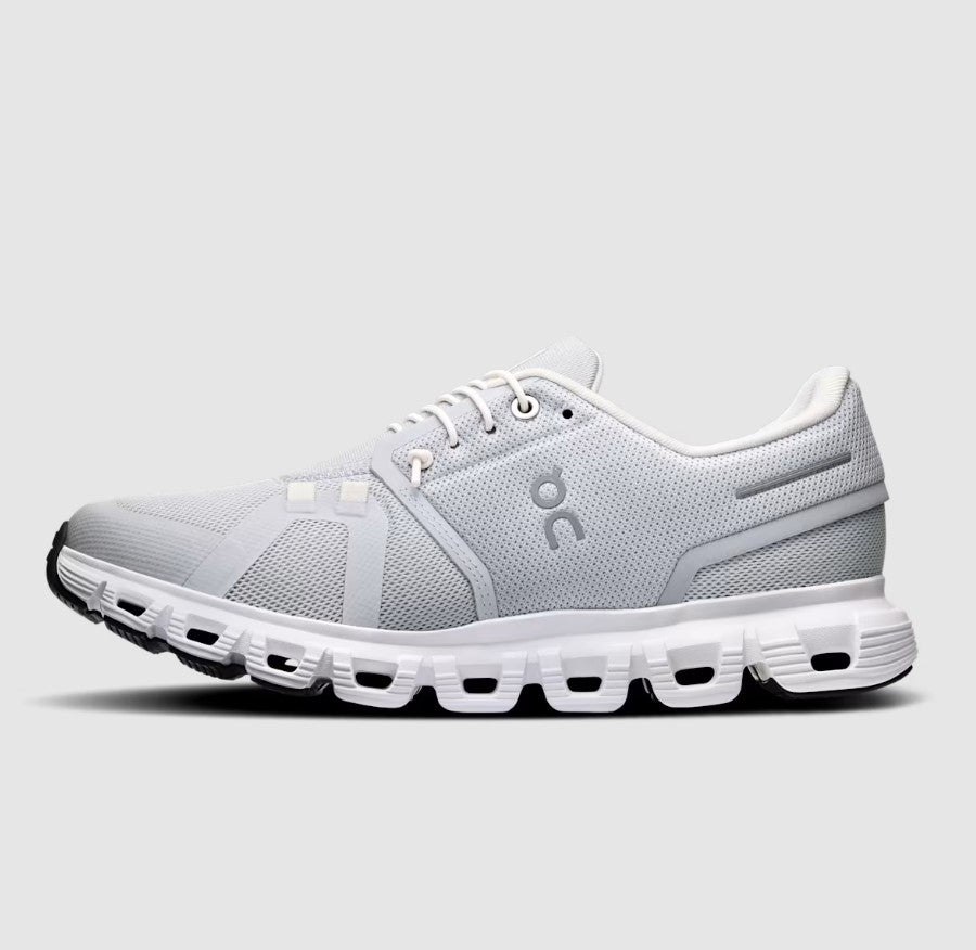 Grey and white running shoe with visible brand logo on a light gray background