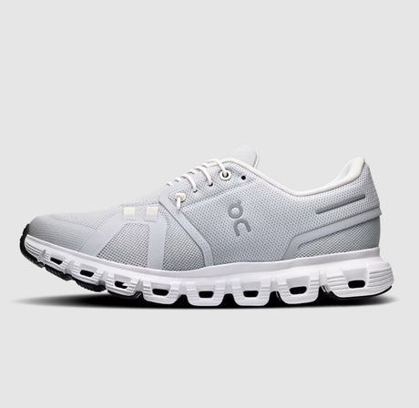 Grey and white running shoe with visible brand logo on a light gray background
