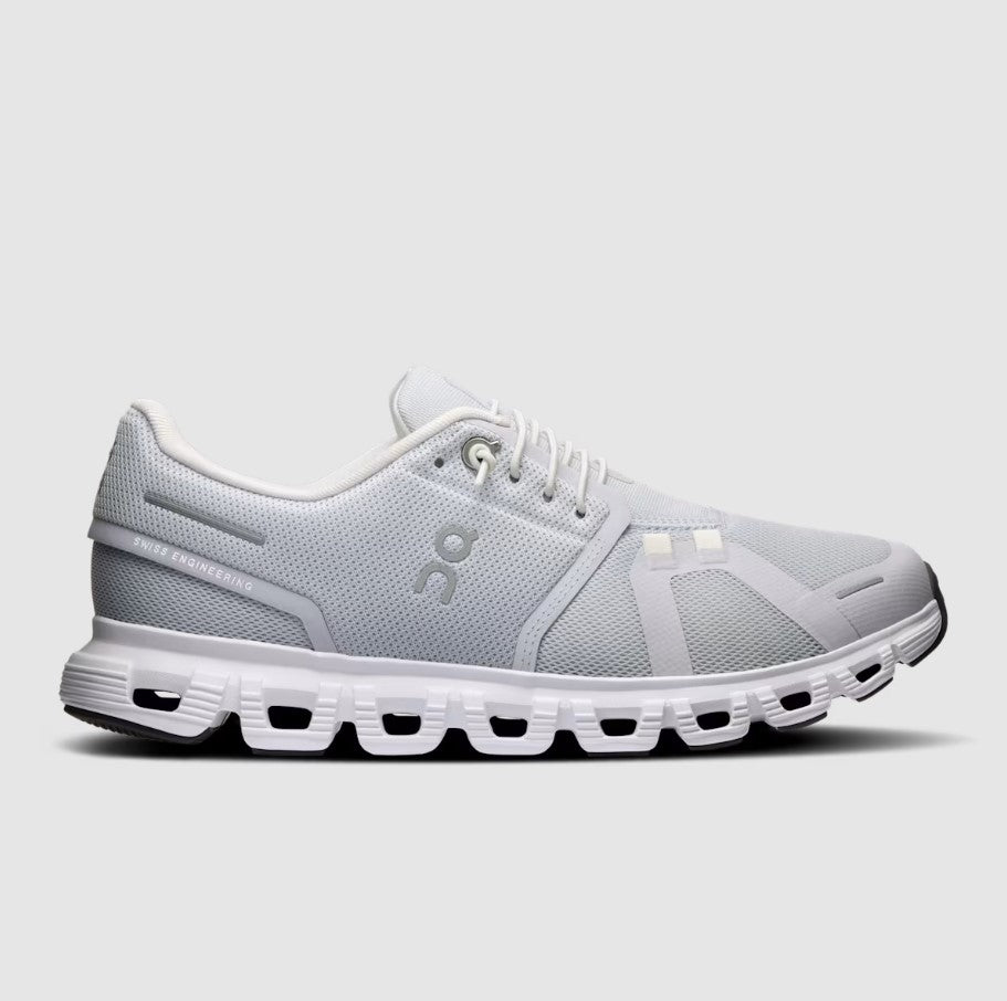 Grey and white running shoe on a light gray background