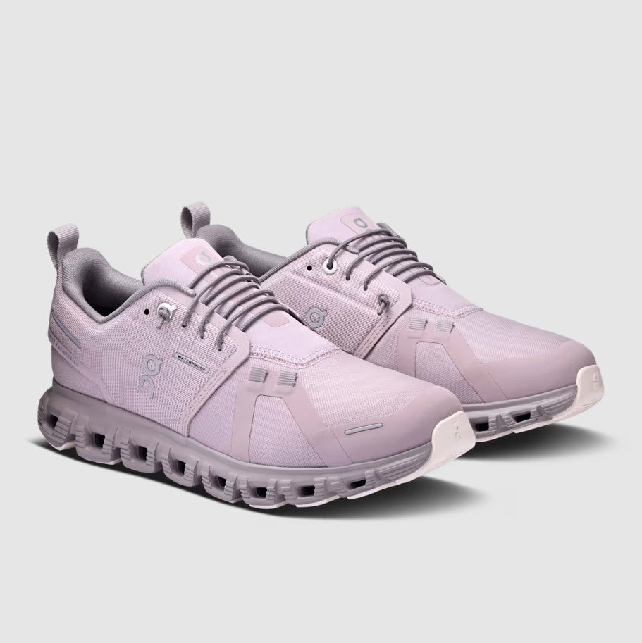 Pair of light purple athletic shoes on a gray background