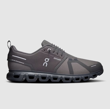 Gray running shoe with black sole on a light gray background