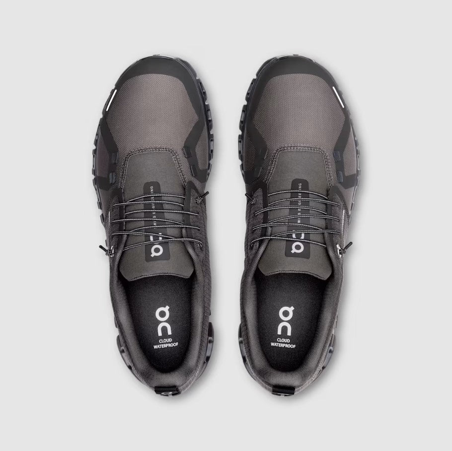 Pair of gray shoes with black accents on a light gray background