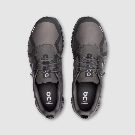 Pair of gray shoes with black accents on a light gray background