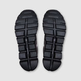 Black athletic shoes with sole pattern on a light gray background