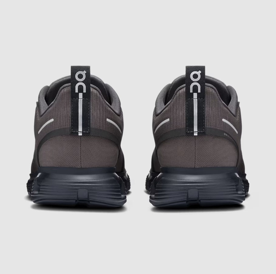 Pair of gray running shoes with visible 'On' branding on a light gray background