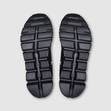 Pair of black shoe soles with a square/rectangle tread pattern on a light gray background