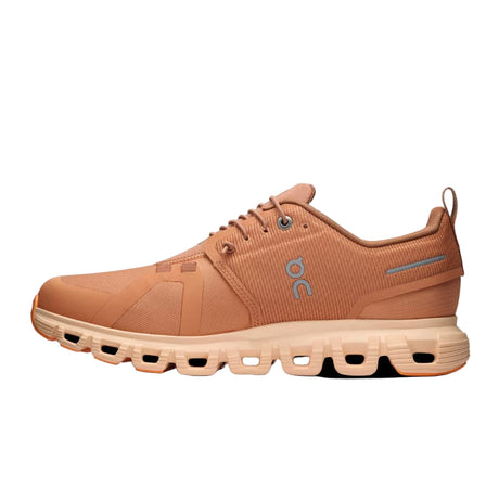 Brown/orange running shoe with visible brand logo on a light gray background