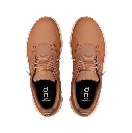 Pair of brown shoes with a visible brand logo on a white background