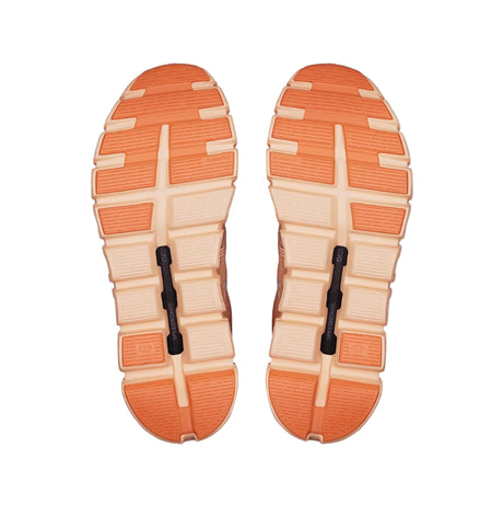 Pair of orange and beige shoe soles on a white background