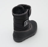 a black kamik boot from the back, featuring a black rubber sole and black fur lining