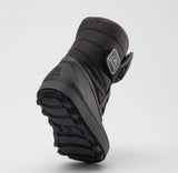Bottom sole of a black Kamik toddler boot, featuring a black rubber bottom