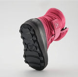 a bright pink kamik boot from the bottom, featuring a black rubber bottom sole