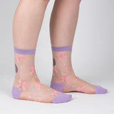 Sheer socks with pink bows and purple accents on a light gray background