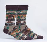 Socks with a nature-themed pattern featuring bears, cabins, and trees on a white background.