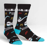Music-themed socks with instruments and notes on a black background