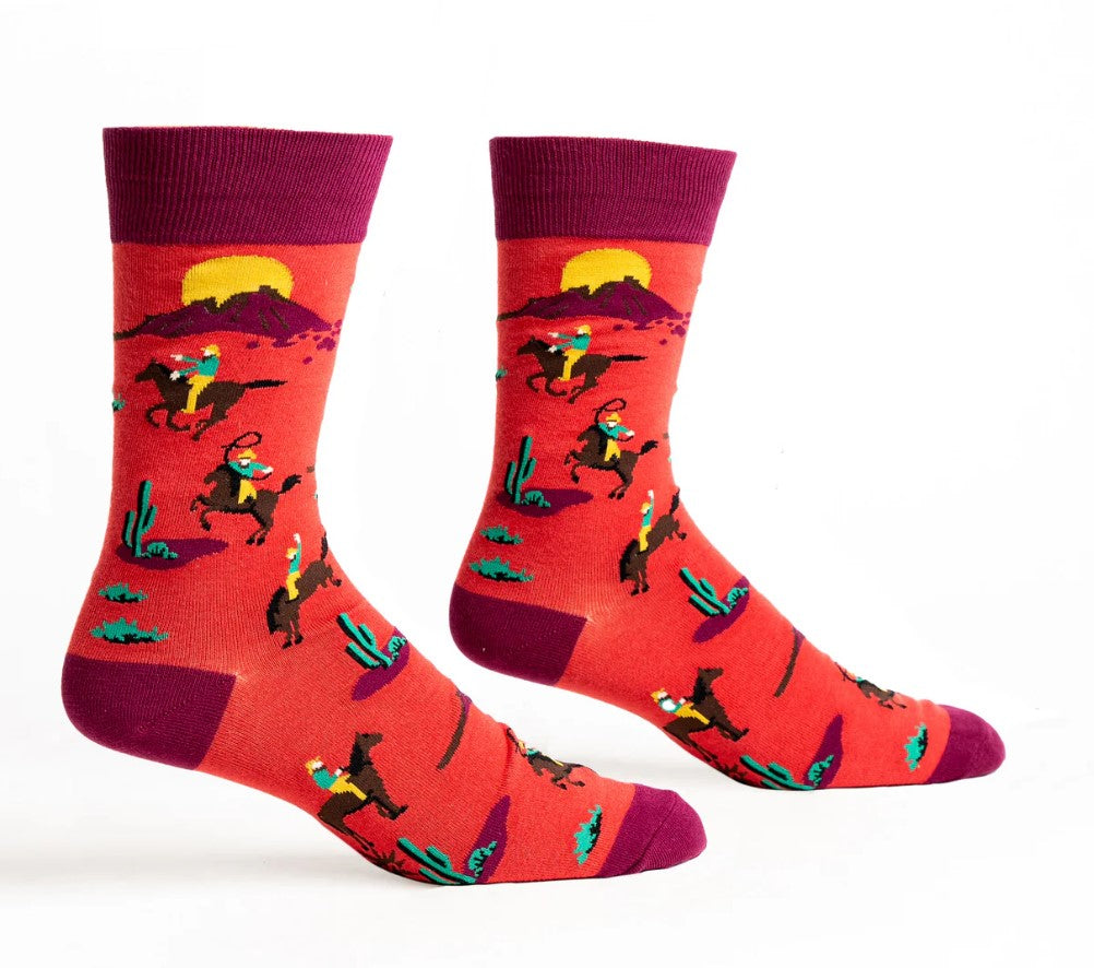 Red socks with cowboy and horse design on a white background