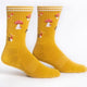 Pair of yellow socks with mushroom pattern on a white background