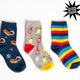 Three pairs of socks with different hot dog related, like Weiner dogs and mustard with ketchup designs on a white background