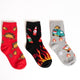 Three pairs of colorful socks with various taco dinosaurs and foo truck designs on a white background