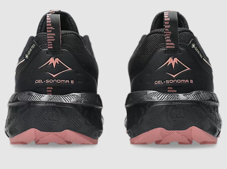 Black and pink running shoes with brand logo on a light gray background