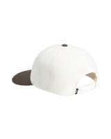 White and brown snapback cap on a light gray background
