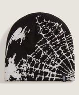 Black and white patterned beanie with Vans logo on a light gray background