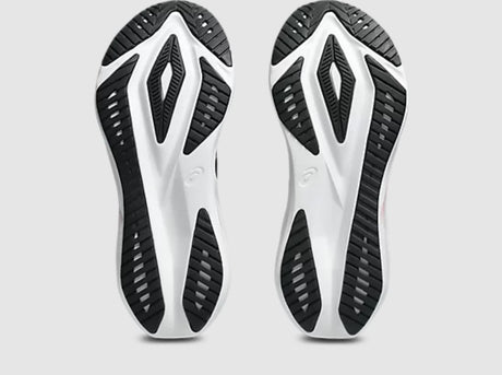 Close-up of a pair of white and black athletic shoes on a light gray background