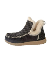 A single slip-on ankle bootie slipper with a dark gray and black houndstooth patterned upper, cream faux-fur lining, and a tan rubber sole, shown against a light gray background.